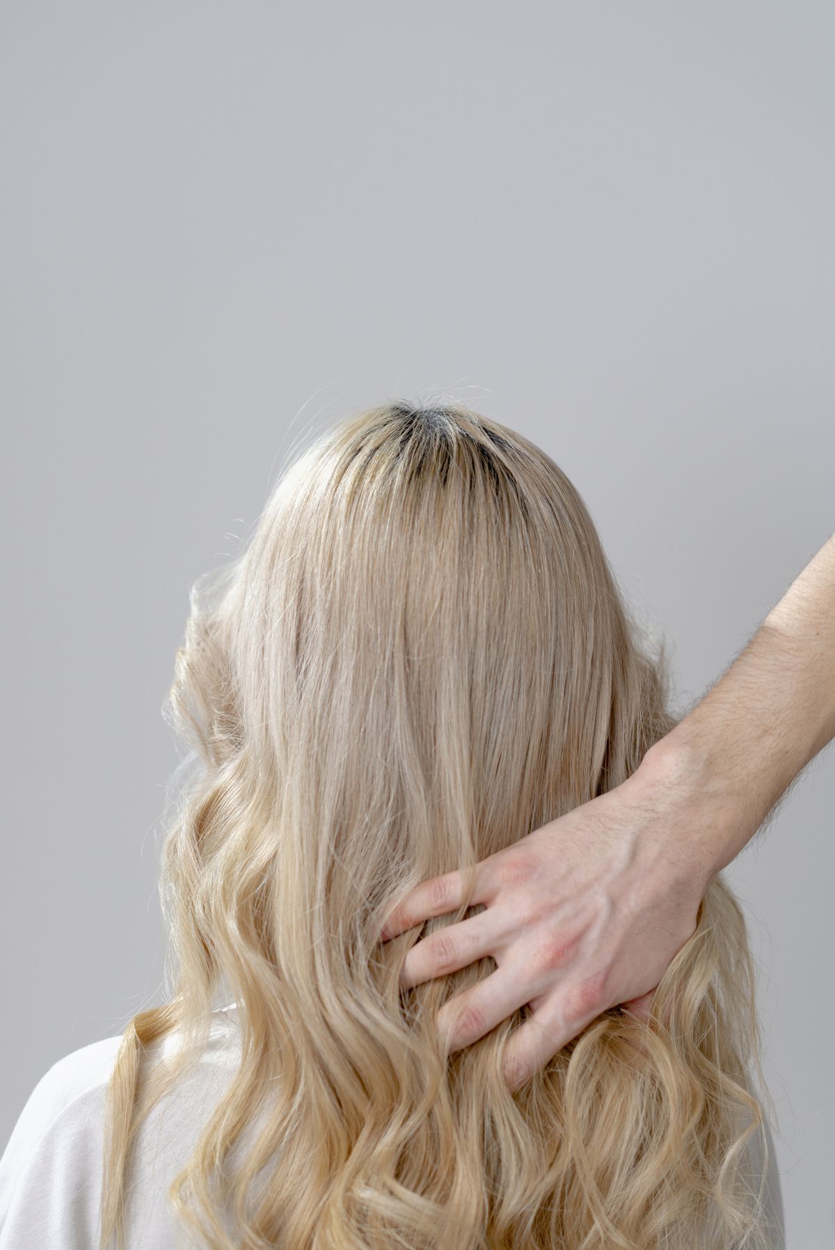 Long blonde waves being styled at the salon